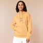 Light yellow long sleeve hoodie with embroidered pink and blue design of a cute chibi skateboarding cat with the text some people are just too cool but not me.