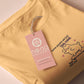 Light yellow short sleeve t-shirt with embroidered pink and blue design of a cute chibi skateboarding cat with the text some people are just too cool but not me.