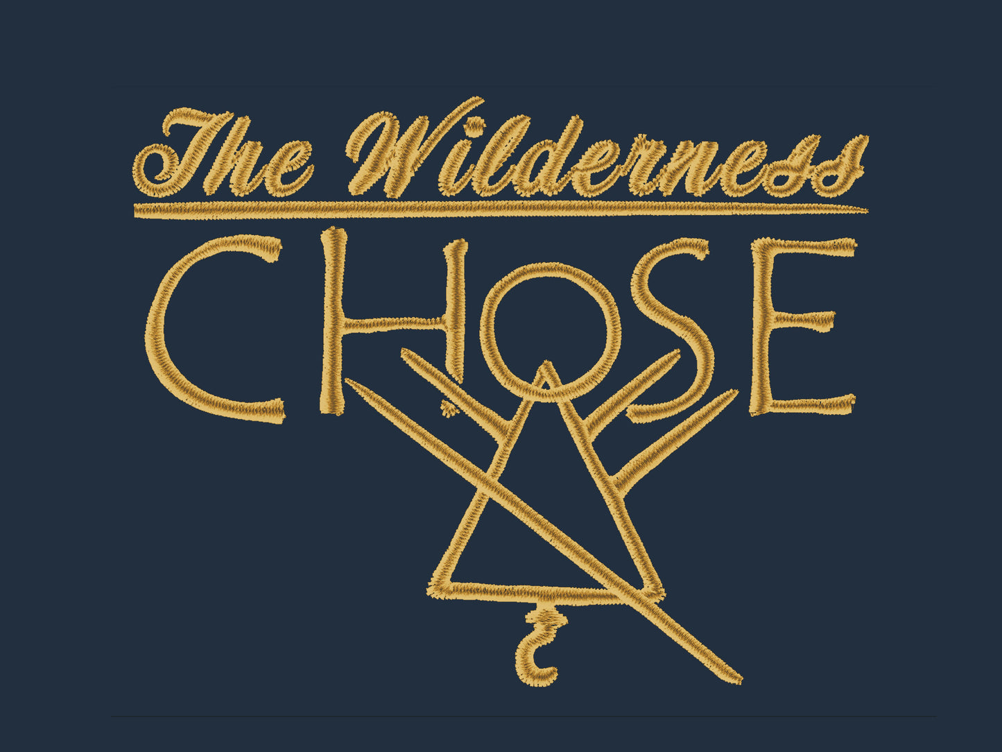 An embroidered yellow design on navy fabric with the quote The Wilderness chose, featuring the cult symbol from the tv show Yellowjackets