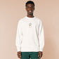 An embroidered white sweater design of a cute cartoon goose wearing a paper hat with text underneath that reads you silly goose.