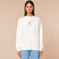 An embroidered white sweater design of a cute cartoon goose wearing a paper hat with text underneath that reads you silly goose.