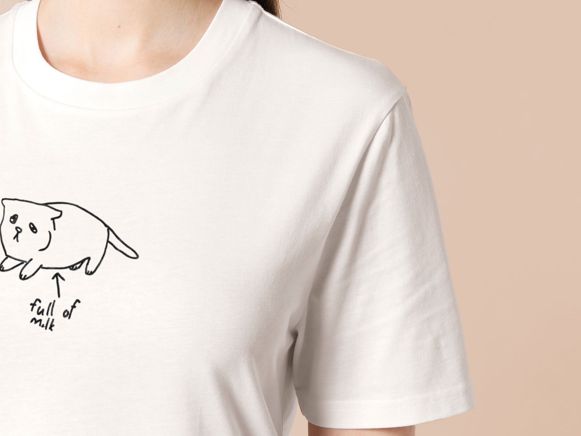Embroidered white t-shirt design of a cute chibi kitten cat with an arrow pointing at its belly and the text full of milk