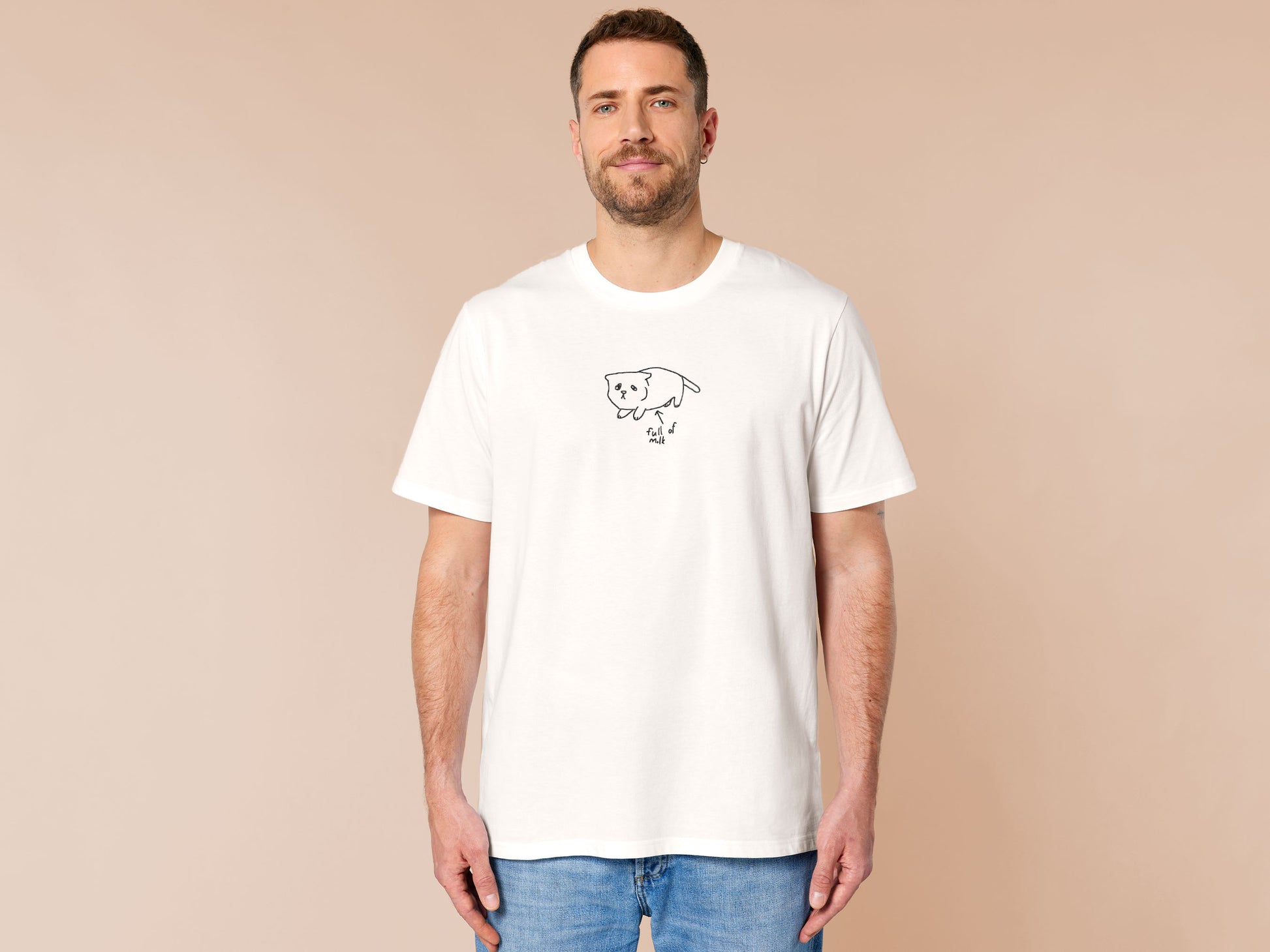 Embroidered white t-shirt design of a cute chibi kitten cat with an arrow pointing at its belly and the text full of milk