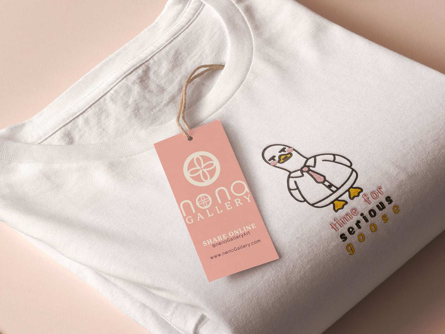An embroidered white t-shirt design of a cute cartoon goose wearing a suit and tie with text underneath that time for serious goose