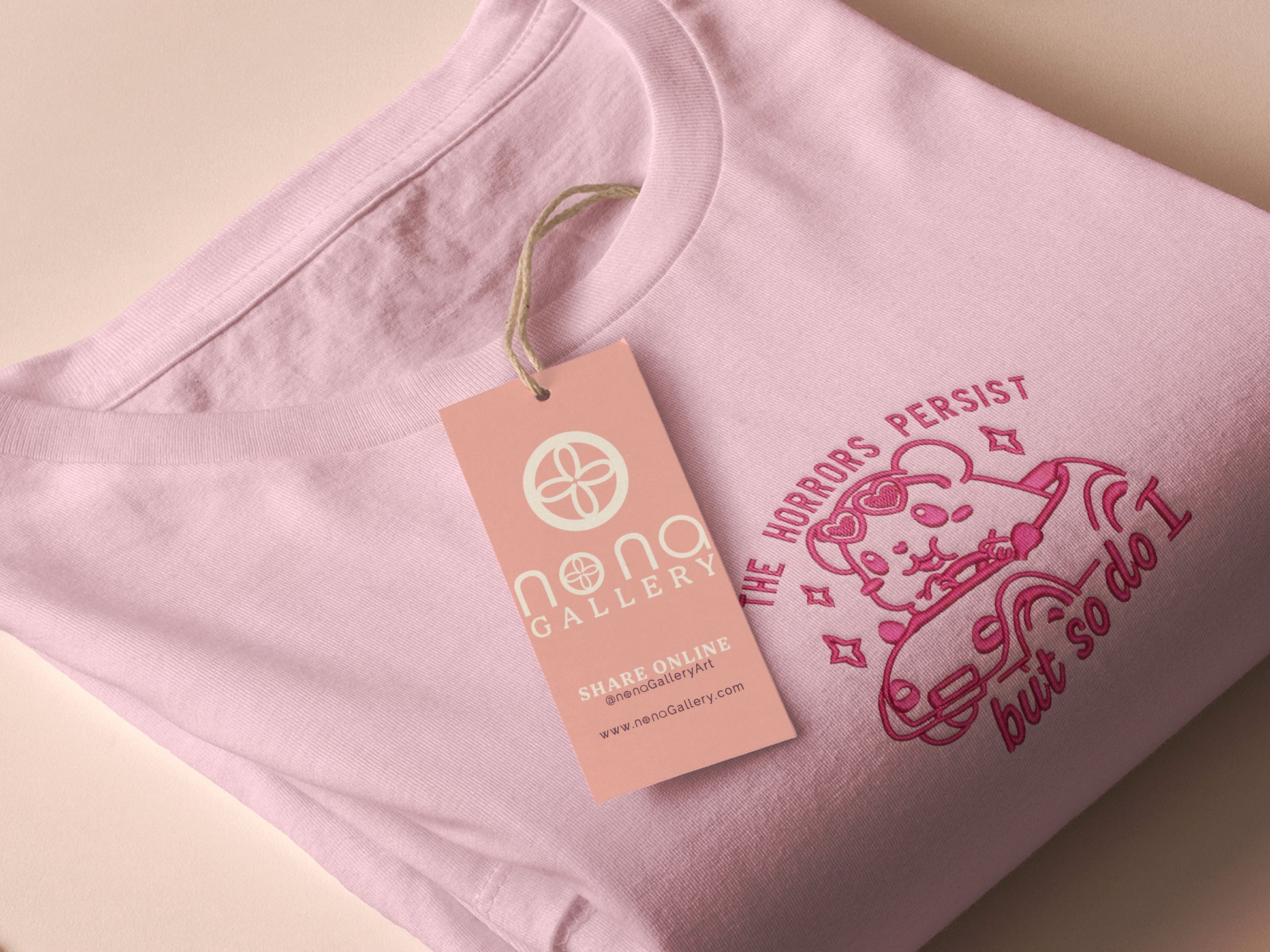 Pink embroidered t-shirt with a cute chibi guinea pig hamster wearing heart-shaped sunglasses and driving a little pink car surrounded by the quote the horrors persist but so do I.