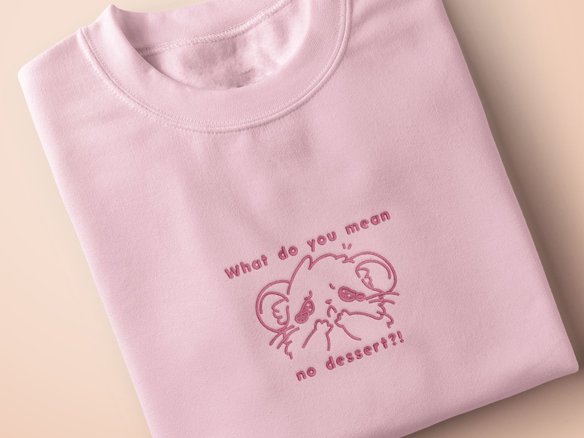 T-shirt with an embroidered Pink Design of a crying chibi hamster with the text what do you mean no dessert?!
