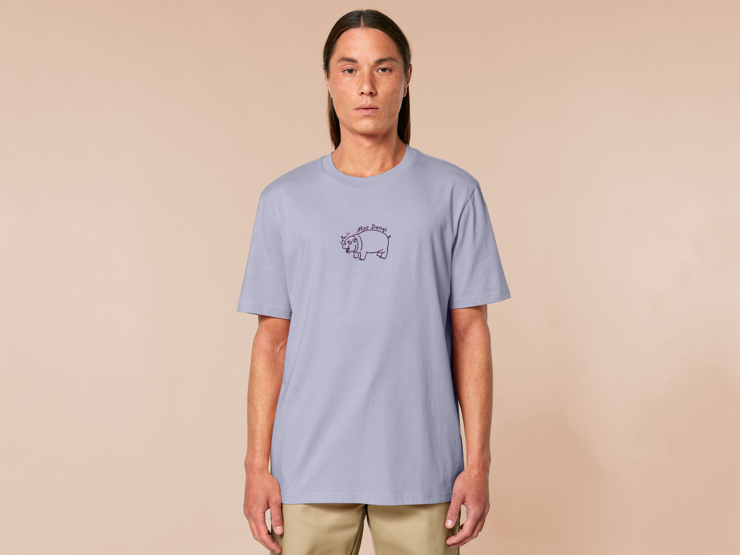 A purple t-shirt with an embroidered design of a cute chibi illustration of the viral baby pygmy hippo looking shocked with the quote Moo Deng!