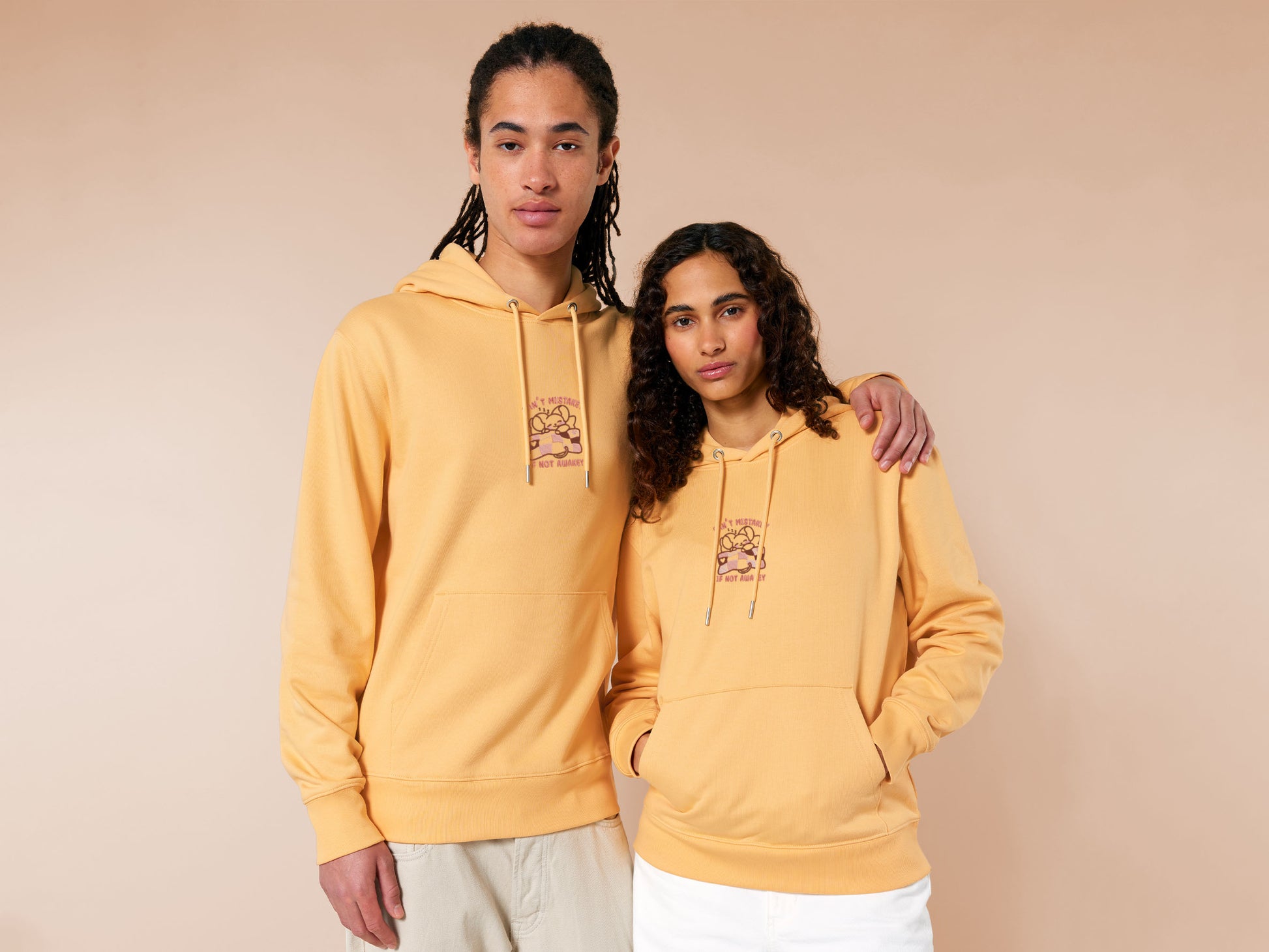 Yellow hoodie with an embroidered mouse sleeping under a patchwork blanket with the text can't mistakey if not awakey