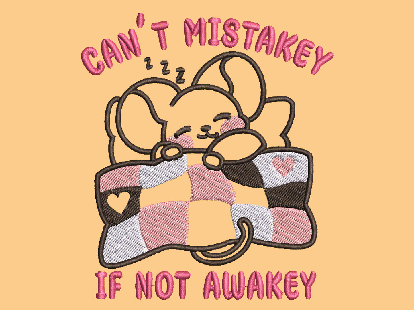 Yellow t-shirt with an embroidered mouse sleeping under a patchwork blanket with the text can't mistakey if not awakey