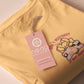 Yellow t-shirt with an embroidered mouse sleeping under a patchwork blanket with the text can't mistakey if not awakey
