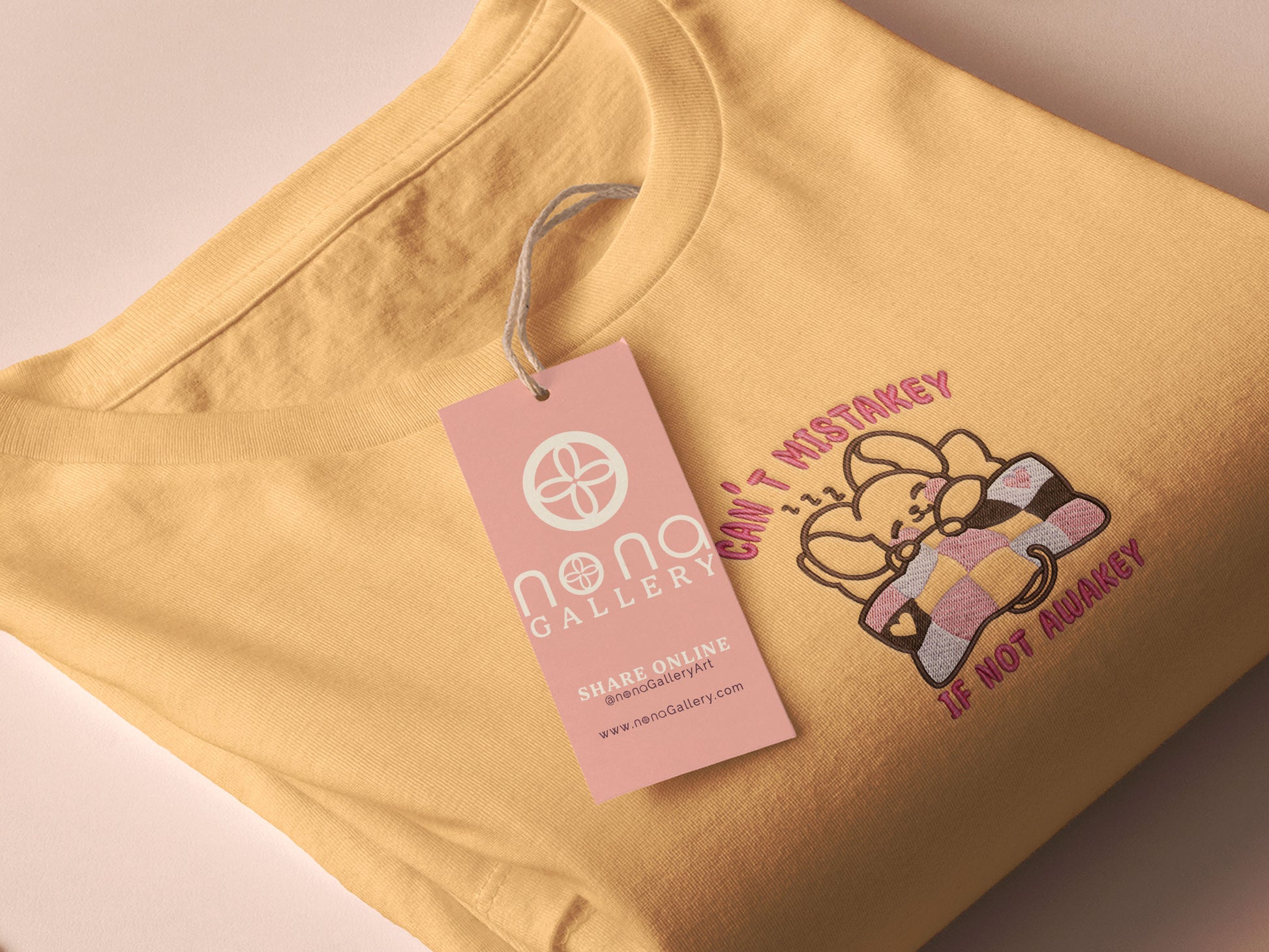 Yellow t-shirt with an embroidered mouse sleeping under a patchwork blanket with the text can't mistakey if not awakey