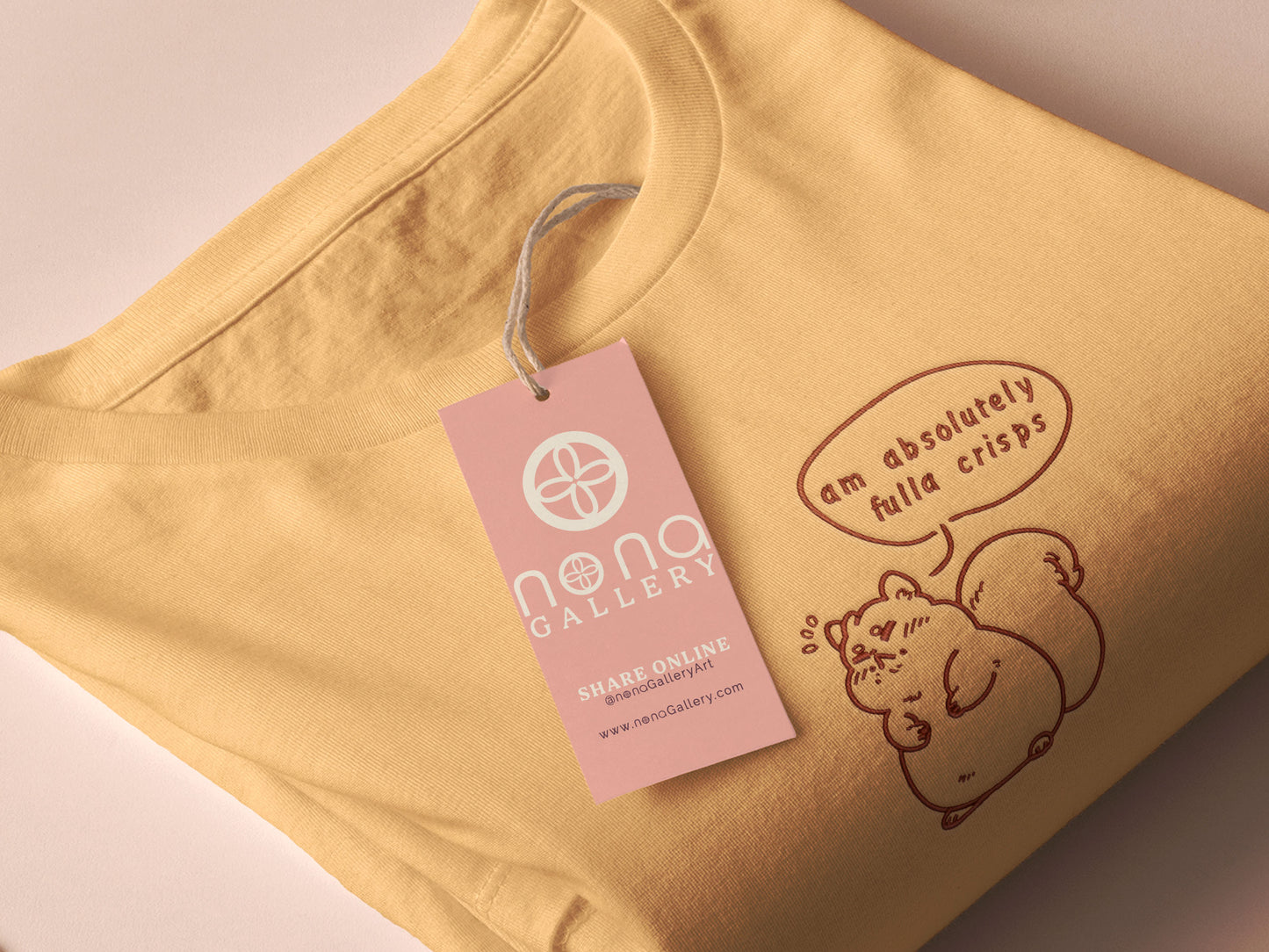 An embroidered yellow t-shirt design of a cute fat chibi squirrel and a speech bubble with the text Am Absolutely Fulla Crisps from the drunken Scottish meme video.