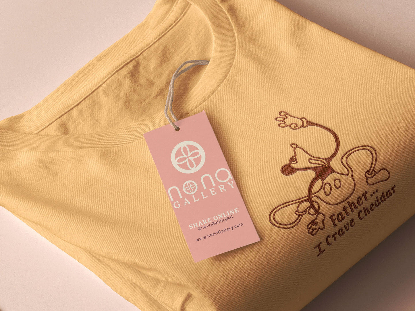 A yellow crew neck short sleeve t-shirt, with an embroidered black thread design of a mickey mouse like creature grasping the air with the text Father... I crave cheddar