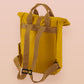 Yellow roll top twin handle backpack with an embroided design of cute crying bear and the quote emotional baggage