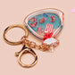 A large transparent acrylic shaker keychain with gold keyring, filled with mini chibi shrimps and labelled as emotional support shrimp