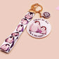 Acrylic epoxy baby penguin keychain with a large acrylic charm of two baby penguins with the quote first of all I'm a delight, a smaller charm of a cute penguin and a matching baby emperor penguin lanyard.