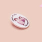 A clear acrylic pin badge with a pink heart-shaped pin back clasp. The design of the pin badge is of a cute baby penguin chicks squabbling with the quote first of all I'm a delight.
