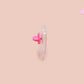 A clear acrylic pin badge with a pink heart-shaped pin back clasp. The design of the pin badge is of a cute baby penguin chicks squabbling with the quote first of all I'm a delight.