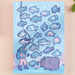 Blue gloss vinyl sticker sheet containing multiple cute funny fish stickers, a treasure chest and anime underwater ocean sea diver stickers