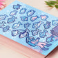 Blue gloss vinyl sticker sheet containing multiple cute funny fish stickers, a treasure chest and anime underwater ocean sea diver stickers