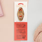Gold Enamel Talisman Pin with yellow and red design and the words Cosplayer's Talisman sits on a long white and red backing card with gold accents. The backing card has details the symbolism of the different design elements of the Talisman pin.