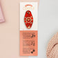 Gold Enamel Talisman Pin with red design and the words couple's Talisman sits on a long white and red backing card with gold accents. The backing card has details the symbolism of the different design elements of the Talisman pin.