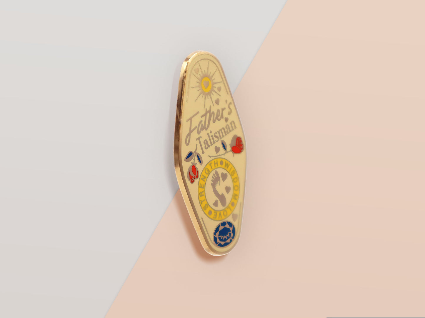 Gold Enamel Talisman Pin with yellow design and the words Father's Talisman, Strength Wisdom Love. The pins design includes a fathers and child's footprint, sunshine, hearts, as well as flowers and crystals.