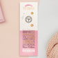 The back of the long white and pink backing card with gold accents. The backing card details the symbolism of the different design elements of the pet owner's Talisman pin. Also shown is the two gold locking pin backs attached to the card.