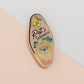 Gold Enamel Talisman Pin and the words Pet Owner's Talisman, unconditional love. The pins design includes a pets collar and a Japanese lucky charm, as well as hearts, flowers and crystals.