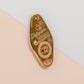 Gold Enamel Talisman Pin with brown design and the words Photographer's Talisman, Ward of bad lighting. The pins design includes a camera and a film, a red bird, as well as flowers and crystals.