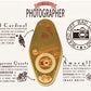 A illustrated diagram outline the symbolism of the different design elements of the for a photographers Talisman pin. Information includes the meaning of the red cardinal, tangerine quartz and amaryllis