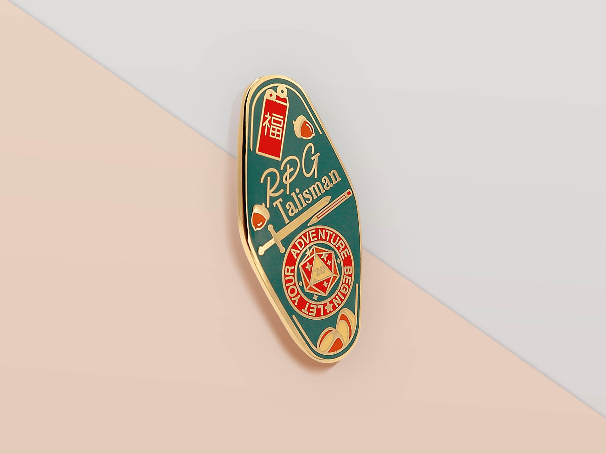 Gold Enamel Talisman Pin with red and blue design and the words RPG Talisman, Let Your Adventure Begin. The pins design includes a D20 dice and a sword and pencil, Hongbao red envelope, as well as acorns and crystals.