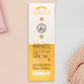 The back of the long white and yellow backing card with gold accents. The backing card details the symbolism of the different design elements of the Teacher's Talisman pin. Also shown is the two gold locking pin backs attached to the card.