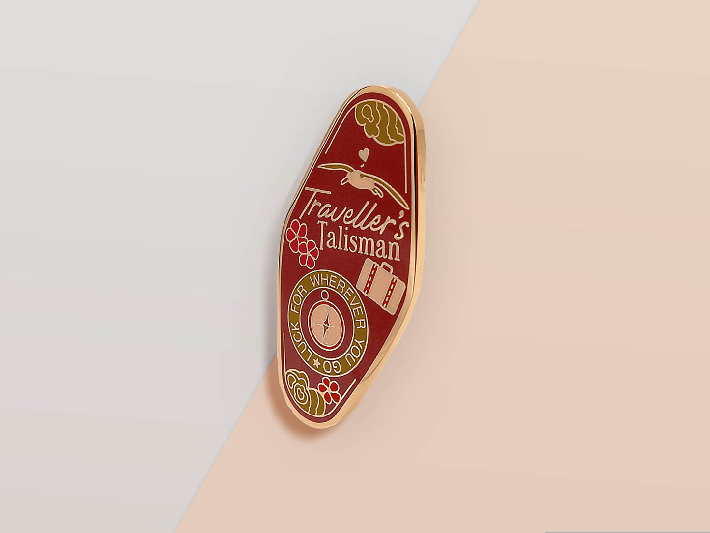 Gold Enamel Talisman Pin with Brown design and the words Traveller's Talisman.