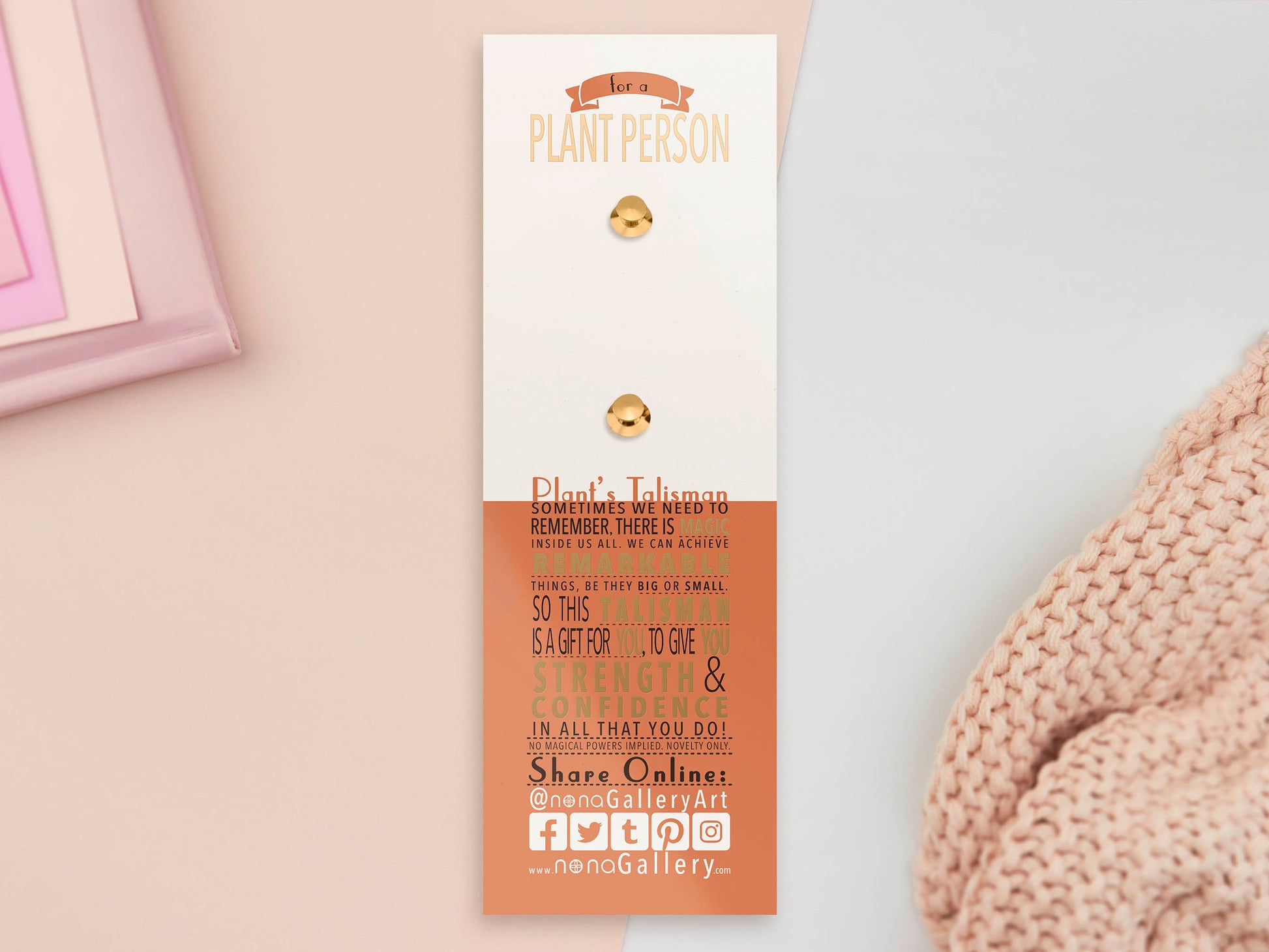 A Plant Person's Talisman gold enamel pin on a gold foiled backing card that outlines the symbolism of the talisman including information and imagery on sliced oranges, heather stems, and moss agate