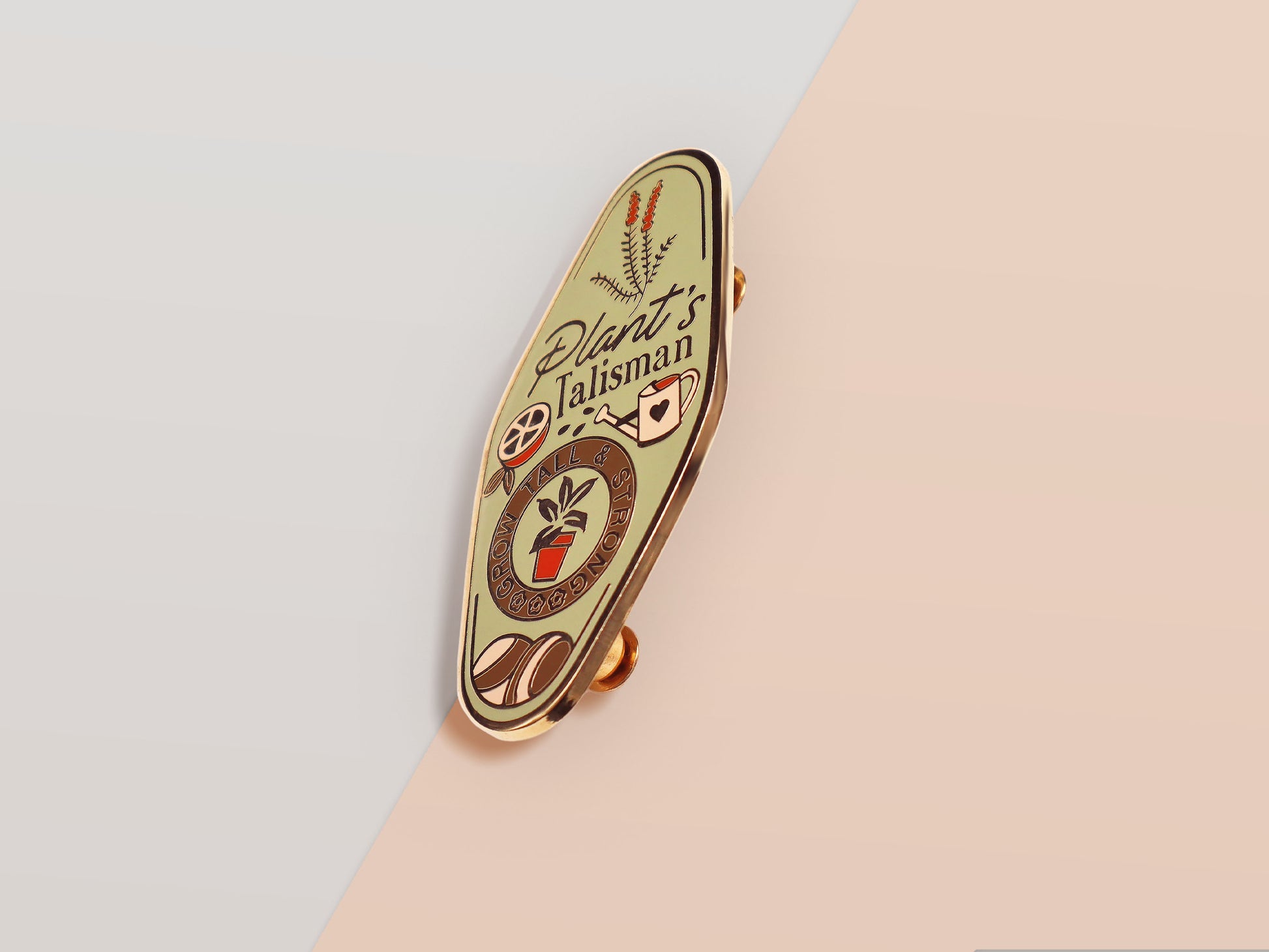 A Plant Person's Talisman gold enamel pin on a gold foiled backing card that outlines the symbolism of the talisman including information and imagery on sliced oranges, heather stems, and moss agate