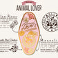 A detailed illustration outlining the symbolism of the Animal Lover's Talisman gold enamel pin on a gold foiled backing card that outlines the symbolism of the talisman