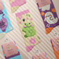 Multiple Cute knitted cotton crew socks with autumn-themed ghost designs, cute cats and kittens, and funny pastel frogs.