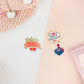 Three peelable stickers the first is a pixelated star design with the text Level Up! and a button that says OK! The second sticker is a speech bubble with the text It is not a waste of time to have fun. The third sticker is a retro joystick controller with a cute face.