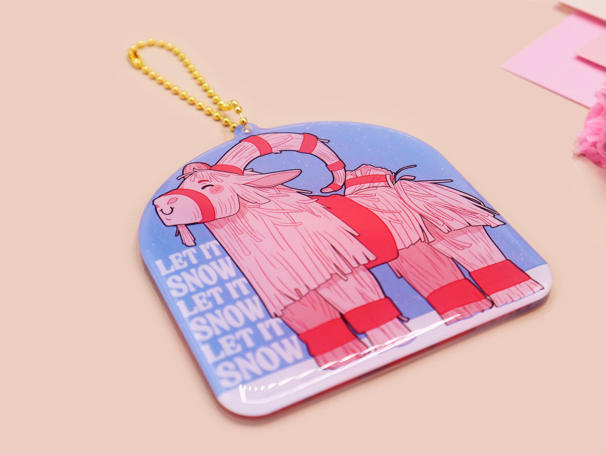 Acrylic epoxy christmas tree hanging decoration with a large acrylic charm of a cute gavle straw goat in the snow with the quote let it snow let it snow let it snow