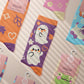 Multiple Cute knitted cotton crew socks with autumn-themed ghost designs, cute cats and kittens, and funny pastel frogs.