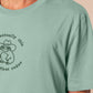 An embroidered green t-shirt design of a cute cowboy frog wearing a stetson surrounded by the test well actually this is my first rodeo.