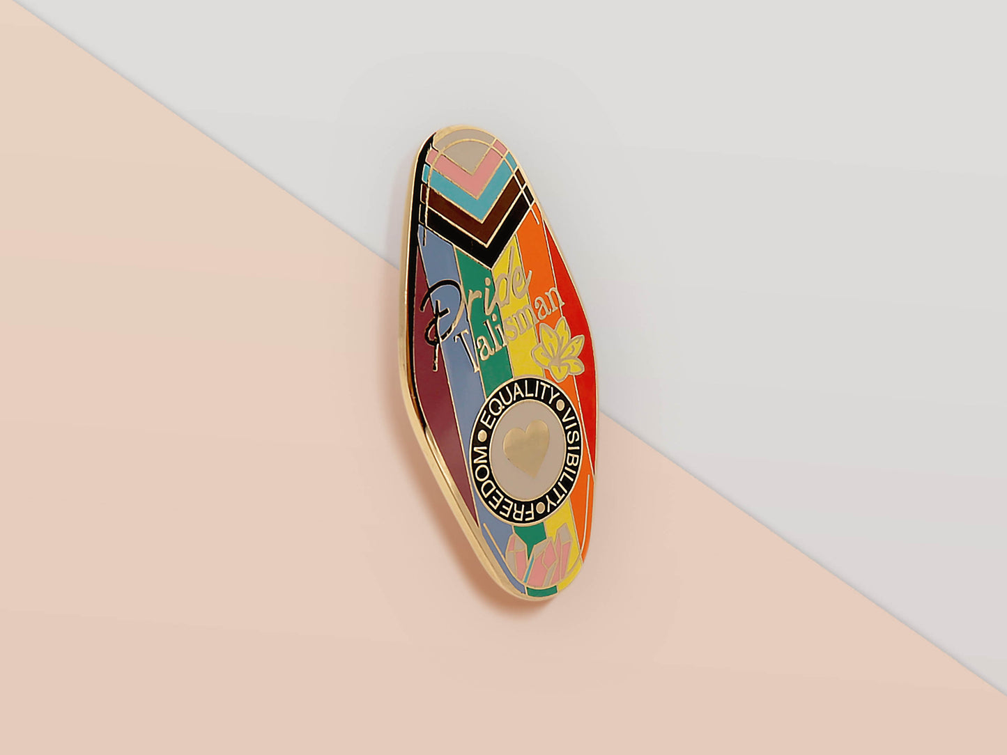 Gold Enamel Talisman Pin with progress pride flag design and the words Pride Talisman, Freedom Equality Visibility. The pins design includes a heart, flowers and crystals.