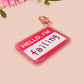 Multiple acrylic keychains with gold swivel clasps in the hello I'm name badge style with the word failing written instead of a name