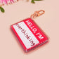 Multiple acrylic keychains with gold swivel clasps in the hello I'm name badge style with the word overthinking written instead of a name