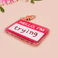 Multiple acrylic keychains with gold swivel clasps in the hello I'm name badge style with the word trying written instead of a name