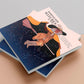 Book front cover a dark skinned witch flying on a broomstick with her cape flowing behind filled with the night sky zodiac consolations the title Horoscope Witches by nona, An astrological guide to understand your magic according to the star signs. 