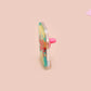 A clear acrylic pin badge with a pink heart-shaped pin back clasp. The design of the pin badge is of a cute chibi retro astronaut floating in sapce with the quote Houston I have so many problems