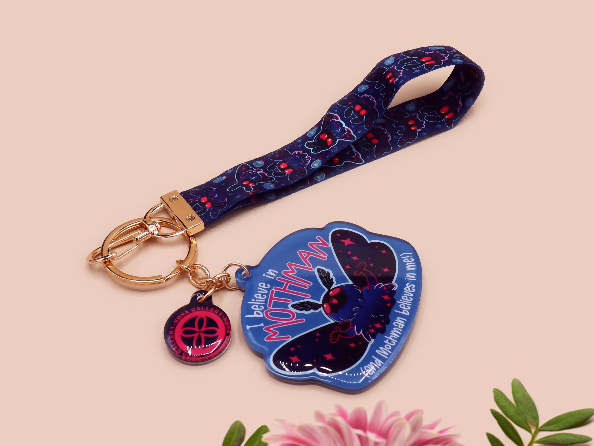 Acrylic epoxy Mothman Cryptid keychain with a large acrylic charm of a cute Mothman with the quote I believe in Mothman and Mothman belives in me, a smaller charm of a cute chibi Mothman and a matching Mothman lanyard.