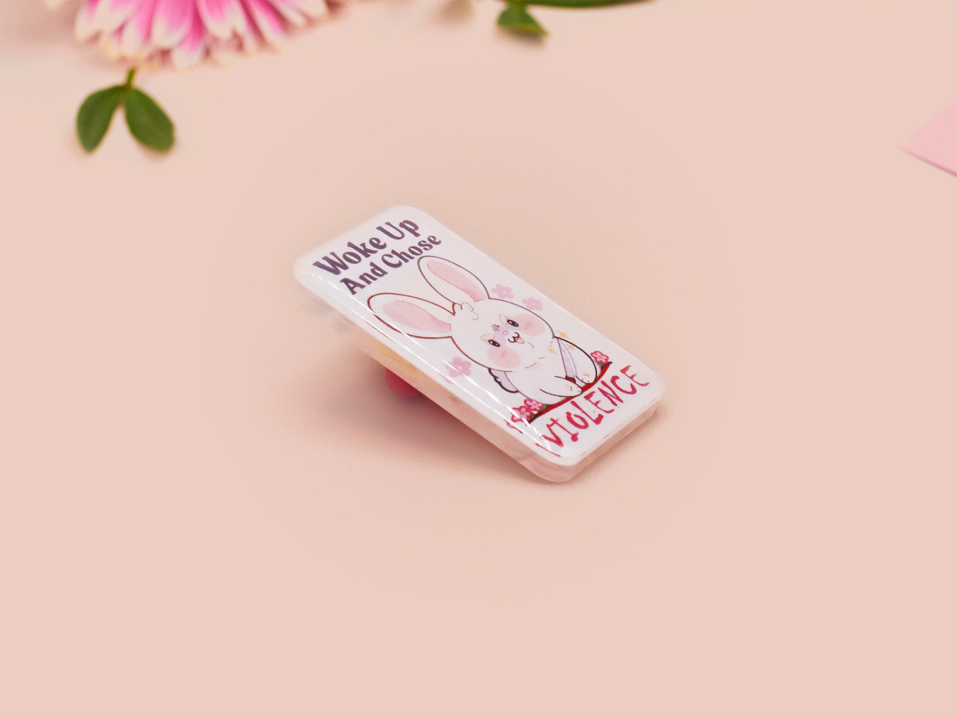 Clear acrylic pin badge with pink heart-shaped rubber pin back clasp. The design of the pin badge is a cute cartoon chibi white rabbit with the quote Woke Up And Chose Violence.